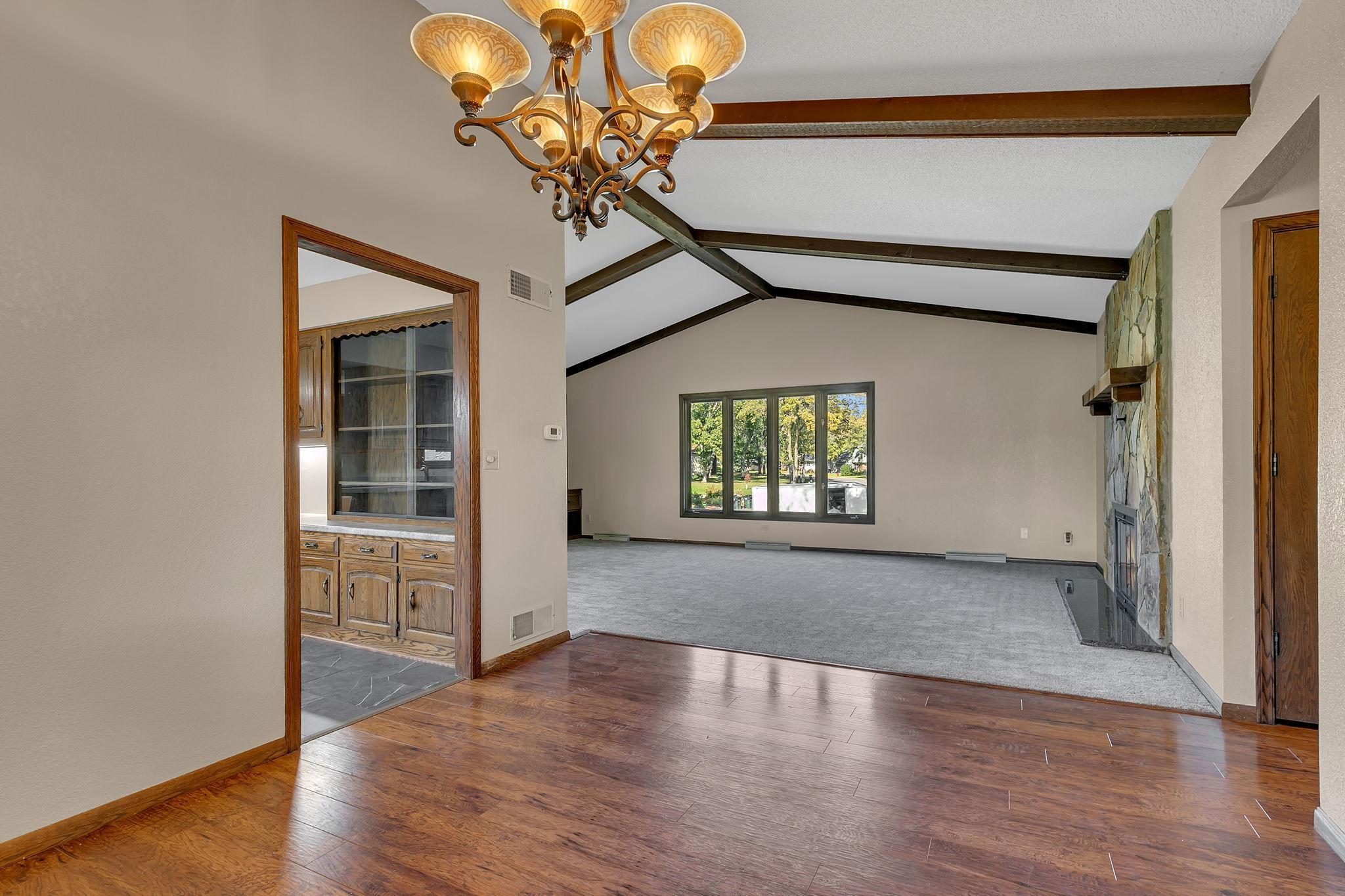 Beamed and vaulted ceilings with updated flooring through much of home