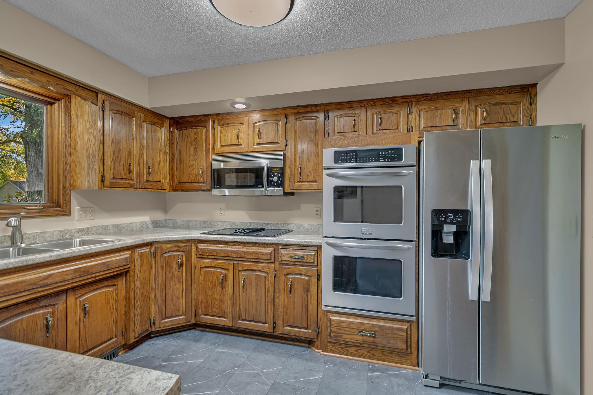 Updated countertops and appliances, complete with double oven and Jenn-Air range