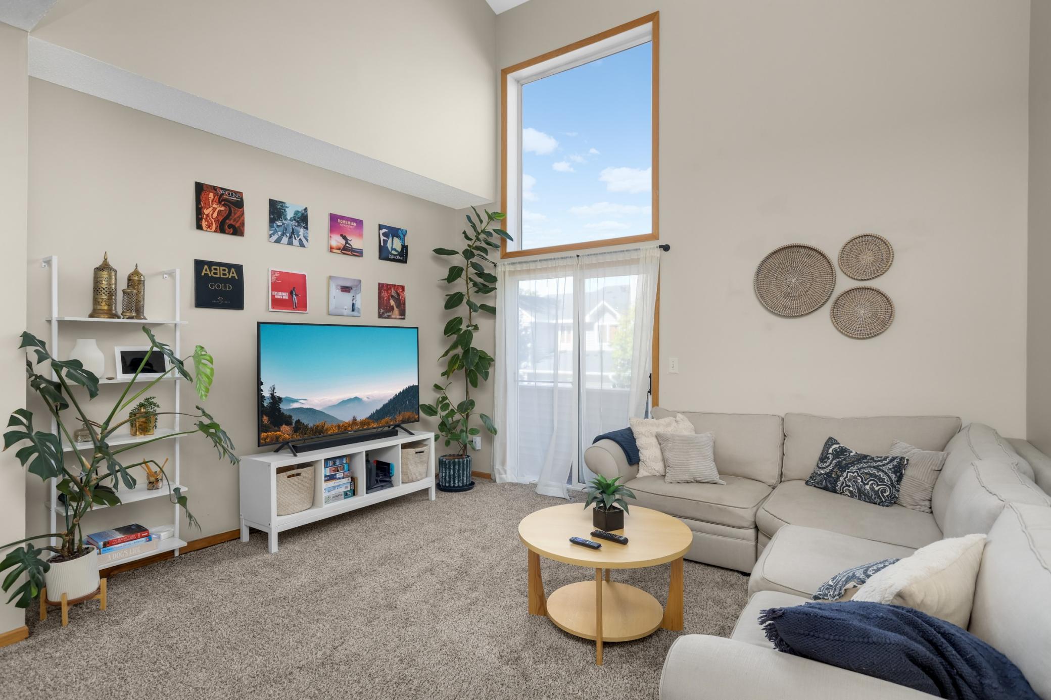 Living room with vaulted ceilings and access to private deck