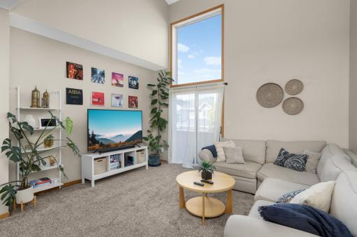 Living room with vaulted ceilings and access to private deck