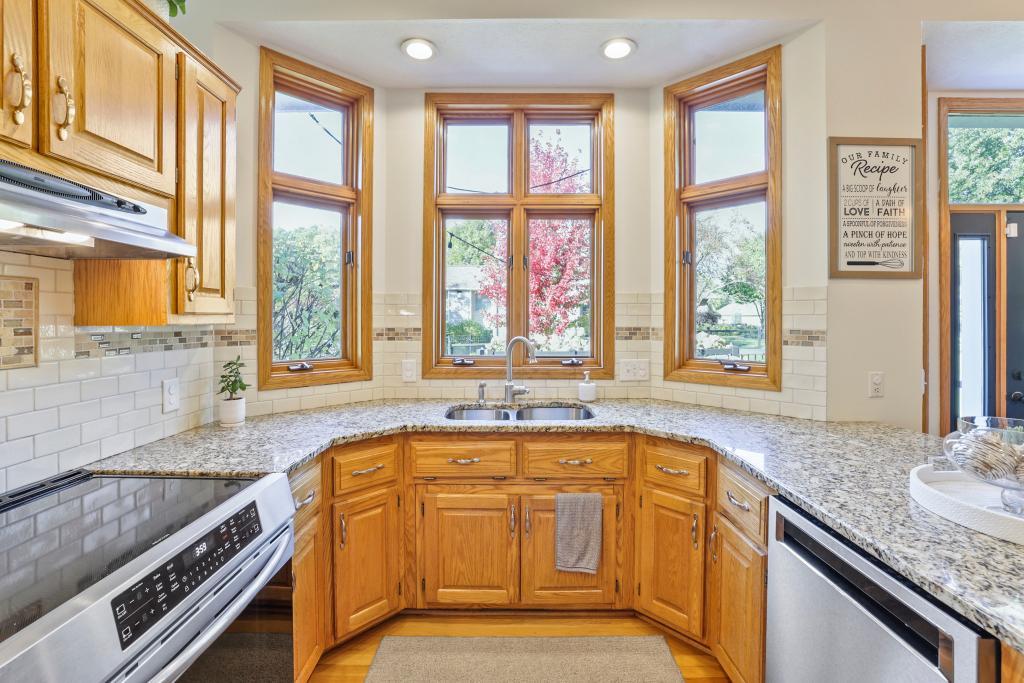 Multiple kitchen windows offer views of deck & private rear yard
