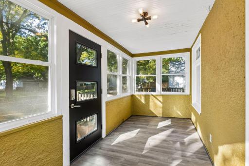 Step inside through the inviting three season porch, a cozy space to relax and enjoy the changing seasons.