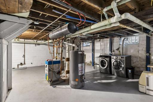 The unfinished lower level provides access to the mechanicals and laundry, along with plenty of additional storage space. New boiler and water heater - 2022