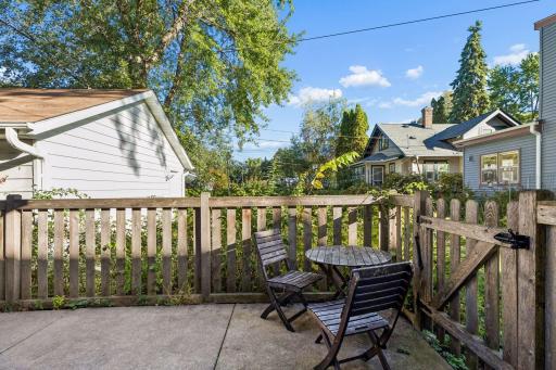 The concrete patio offers a great spot for grilling and outdoor dining in this fenced in area connecting to the detached 1-car garage.