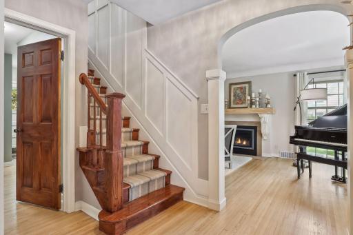 Elegant arched openings between living spaces and wainscoting.