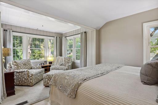 Bright and airy primary bedroom with a charming additional sitting room.