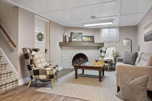 Lower-level family room offers functional fireplace