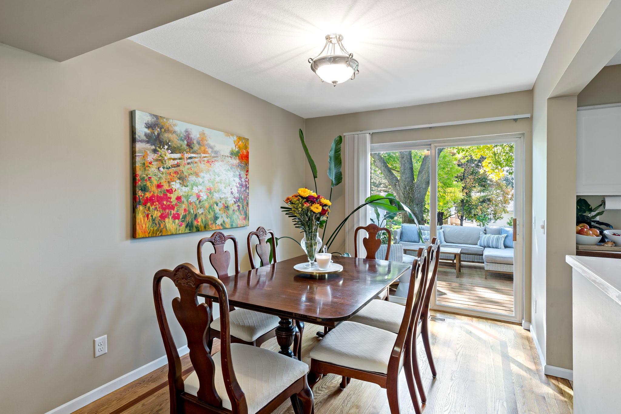 Hardwood floors are featured in the dining room, where a sliding glass door brings in natural light and provides direct access to the outdoor deck—perfect for extending dining and entertaining outdoors.
