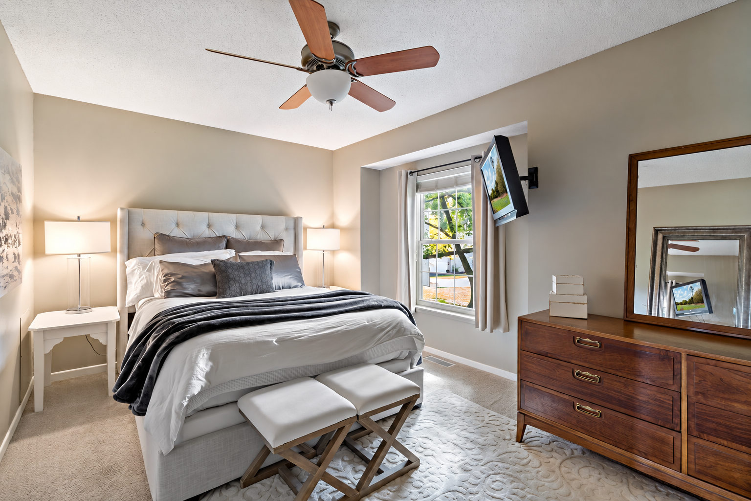 The spacious upper-level primary bedroom offers plenty of room for a bed and additional furniture, while a large window brings in natural light and neighborhood views.