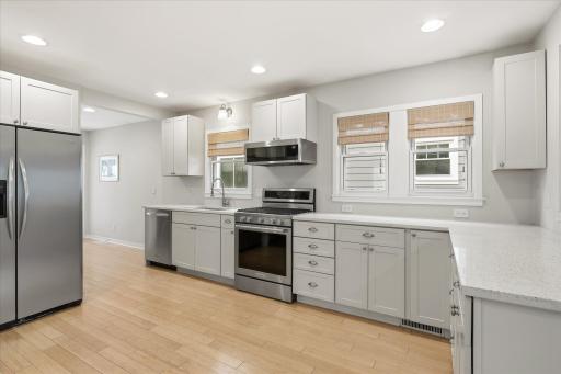 Solid surface counters, gas stove, custom cabinets