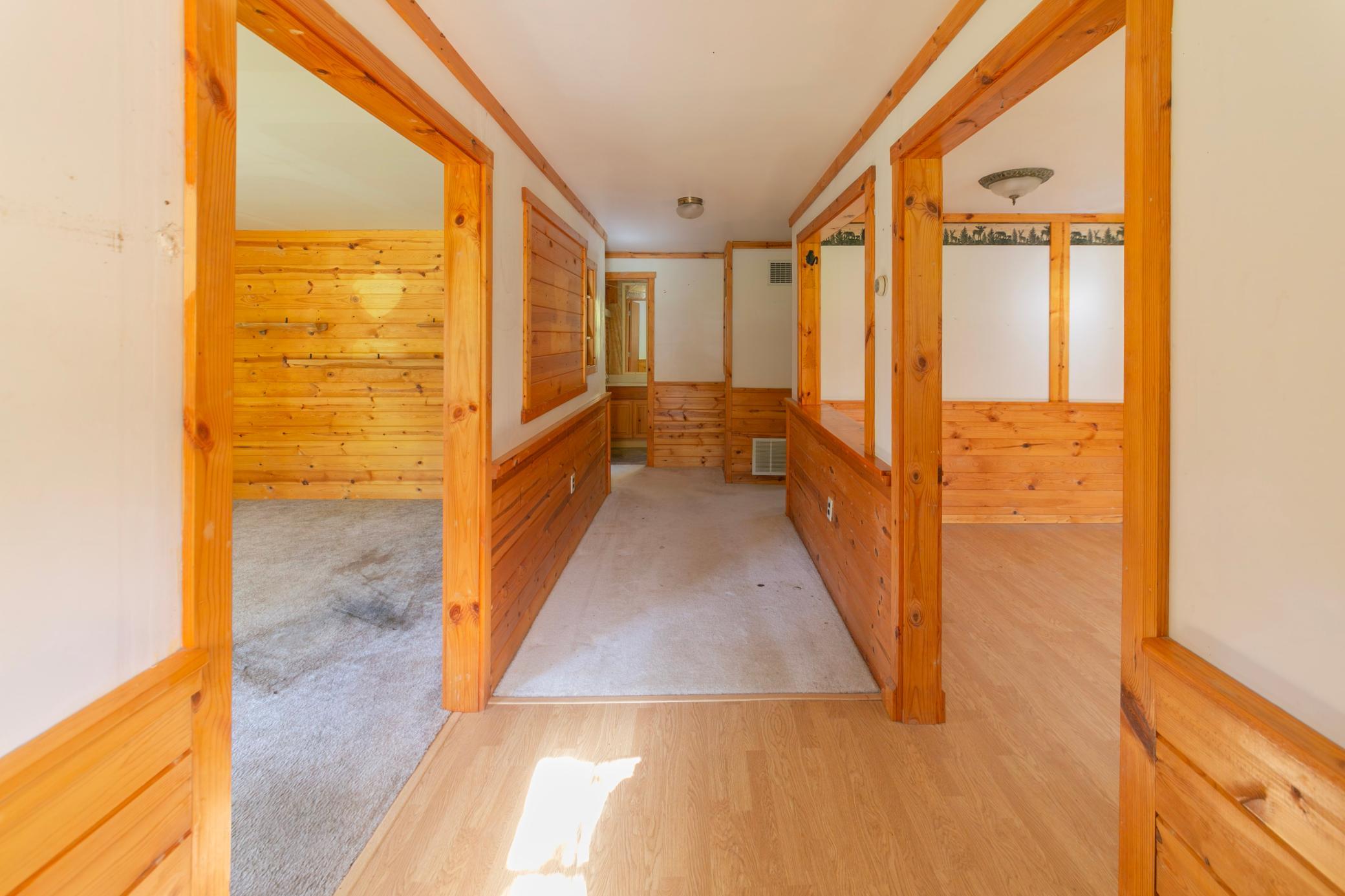 From front entry, to the left is living room, to the right is kitchen, straight ahead is hallway to bathroom and a bedroom on each side.
