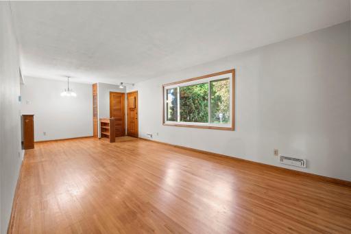 Original oak hardwood floors throughout the living room.