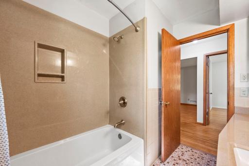 Shower enclosure provides a thoughtful update while preserving the home's original charm.