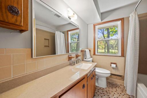 Bathroom on the main floor with tile that is in excellent condition. The tub has been updated.
