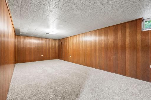 The lower level offers a newly carpeted family room. This is the left-hand side of the room.