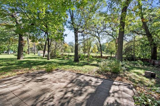 A large paver patio and partially fenced yard provide a wonderful place to relax or entertain.