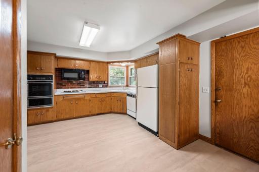 Solid wood cabinets with lots of storage. Two windows over the sink bring in lots of natural light and provide great views of the backyard.