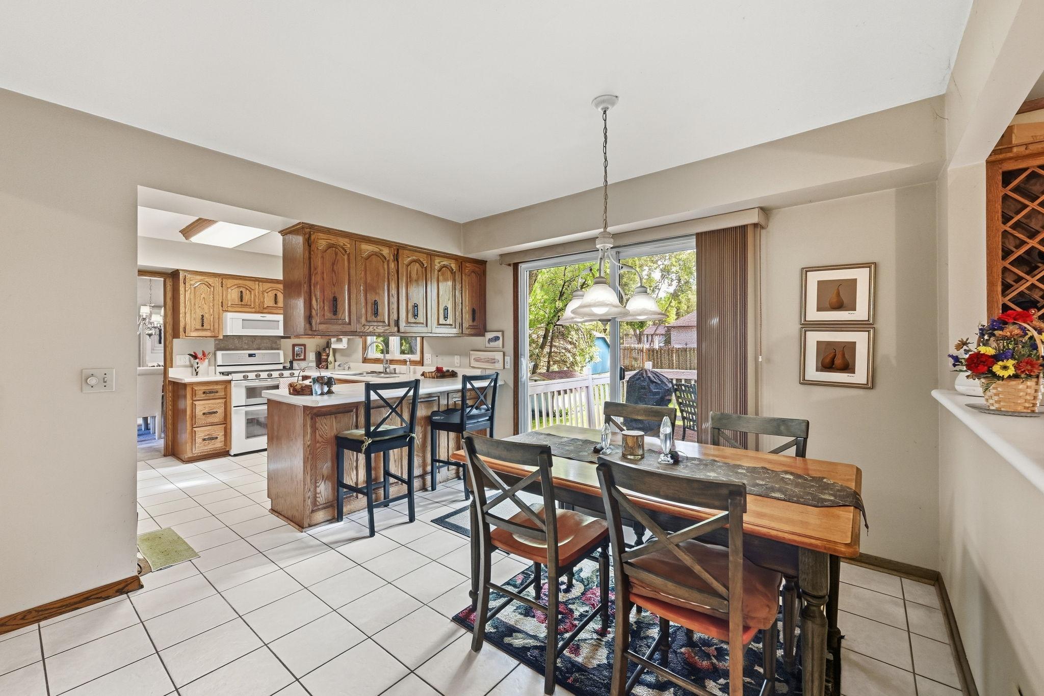 View of the informal dining, kitchen and walkout to the deck