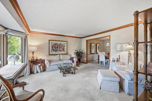 View of the living room from the front entry featuring large, bayed window providing a light and bright room