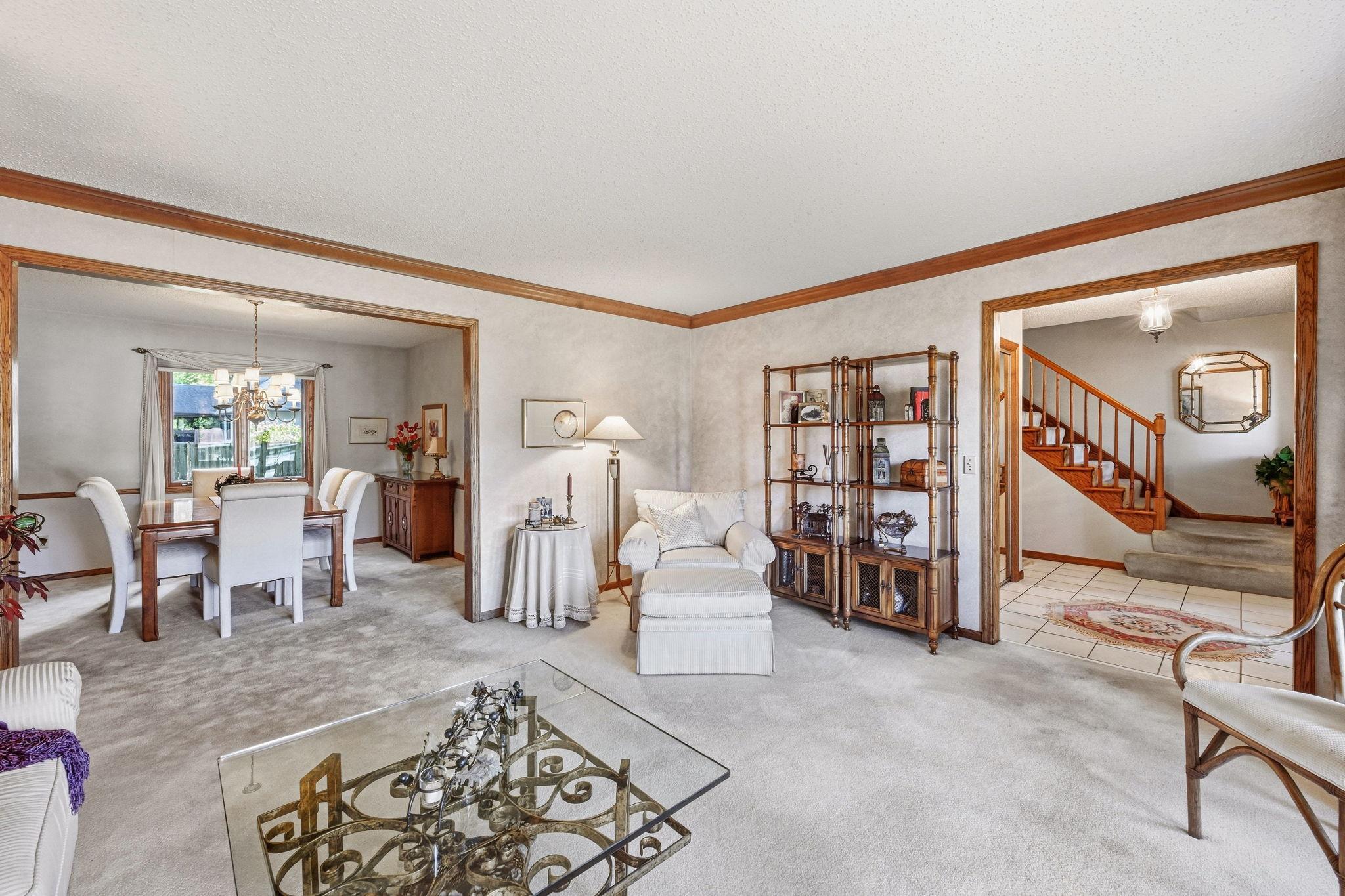 The living room, dining room and the foyer with crown molding