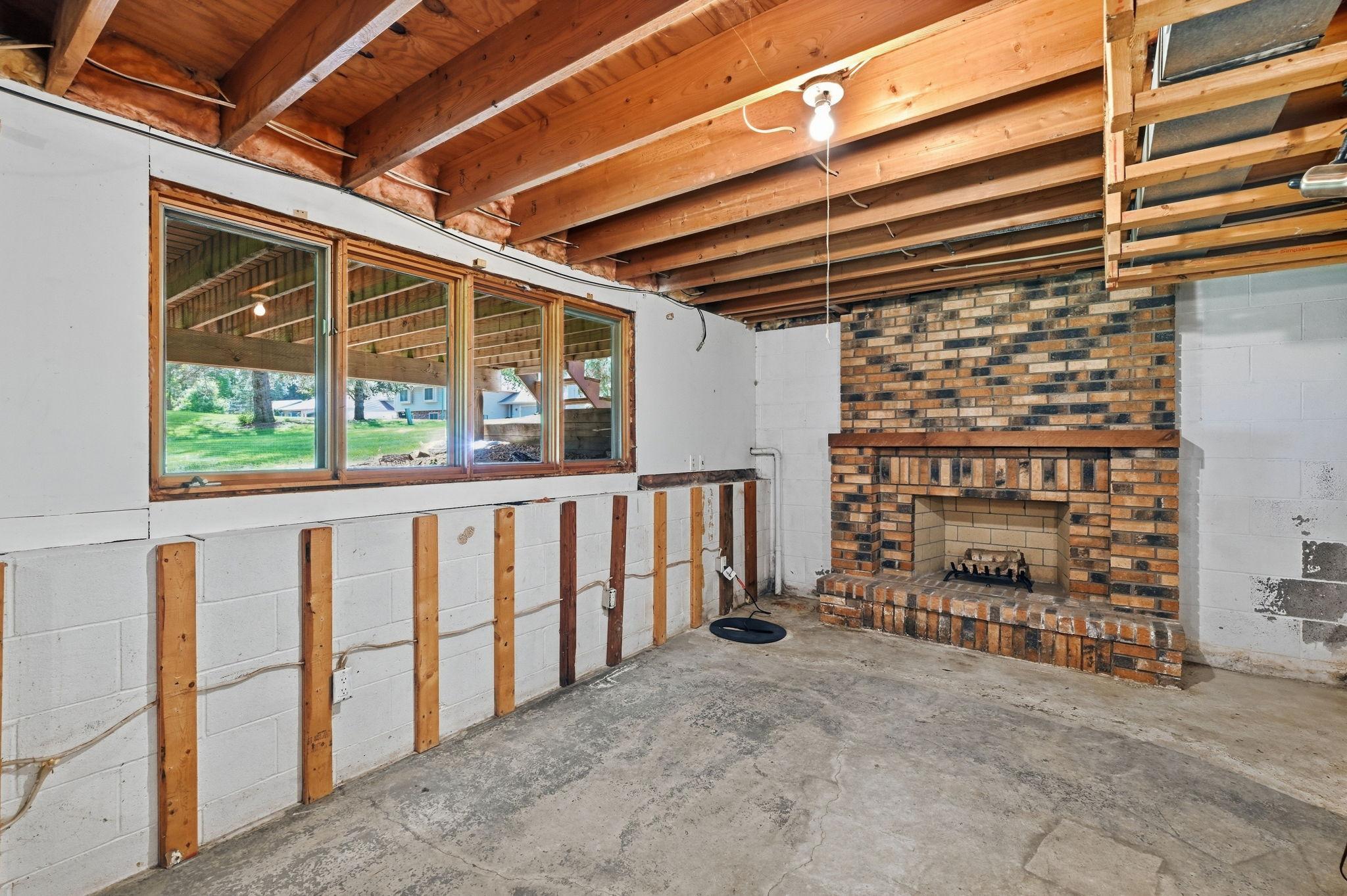 The roughed in full basement features an amusement room with a brick fireplace that has never been used. Nice 3/4 windows too.