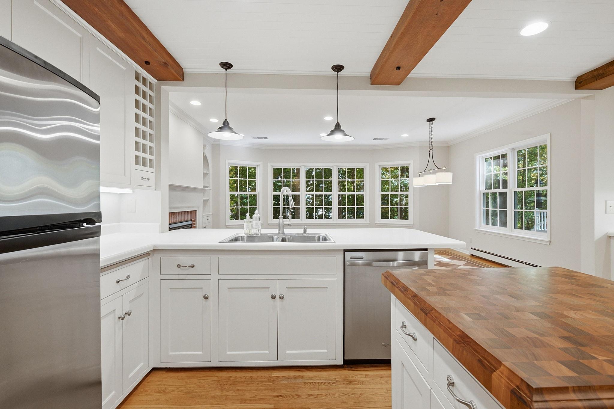 Freshly painted main living areas showcase the stunning exposed beams and charming design details