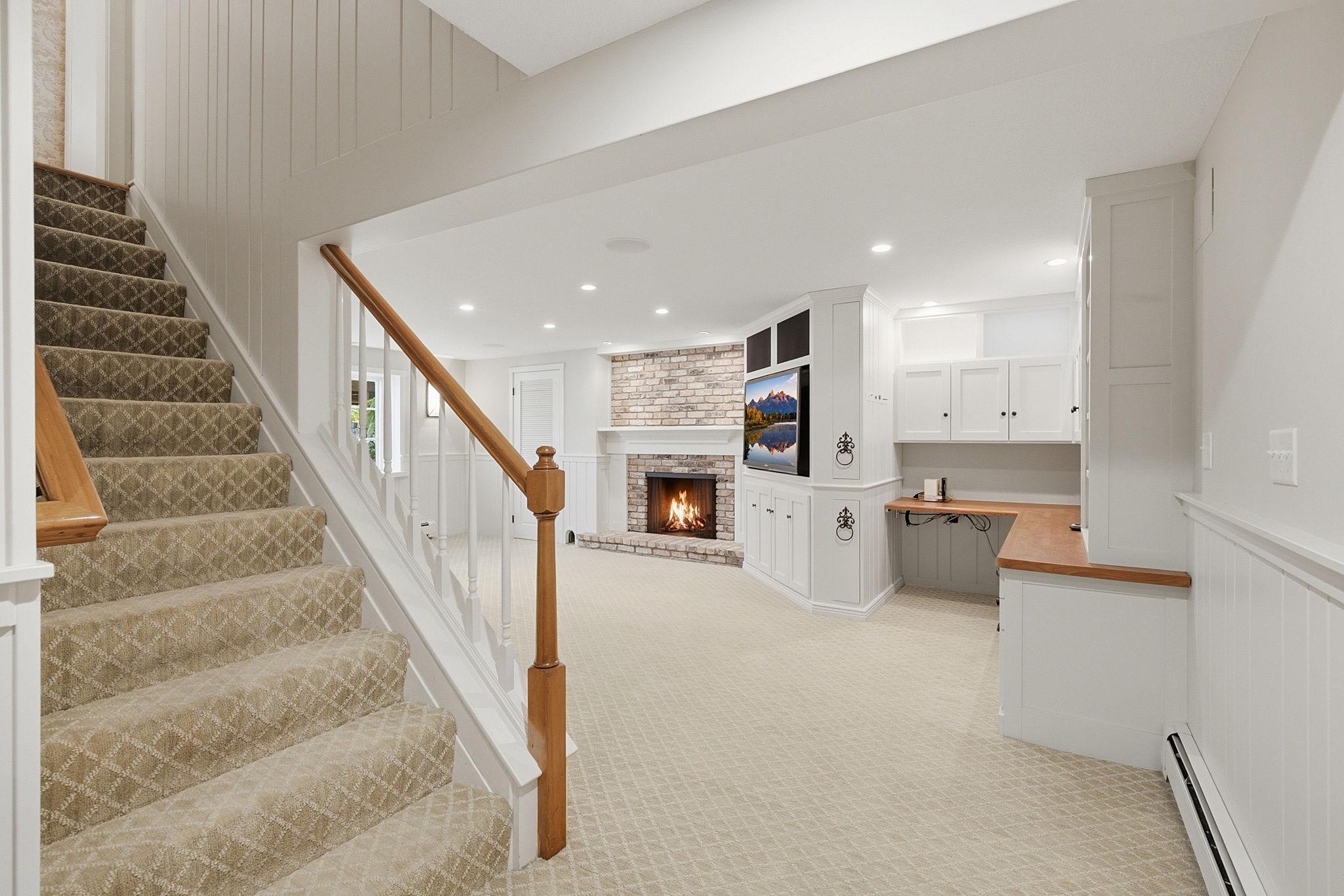 Head down to the lower level family room with cozy wood burning fireplace