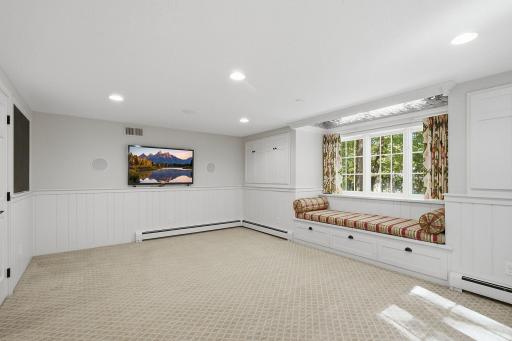 Fourth bedroom on the lower level features a built-in window bench and views of the backyard