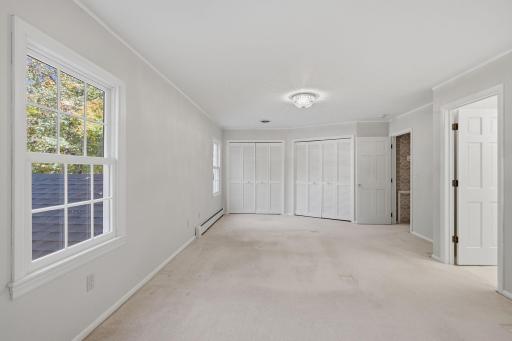 Two separate closets in the primary bedroom; this space has been freshly painted