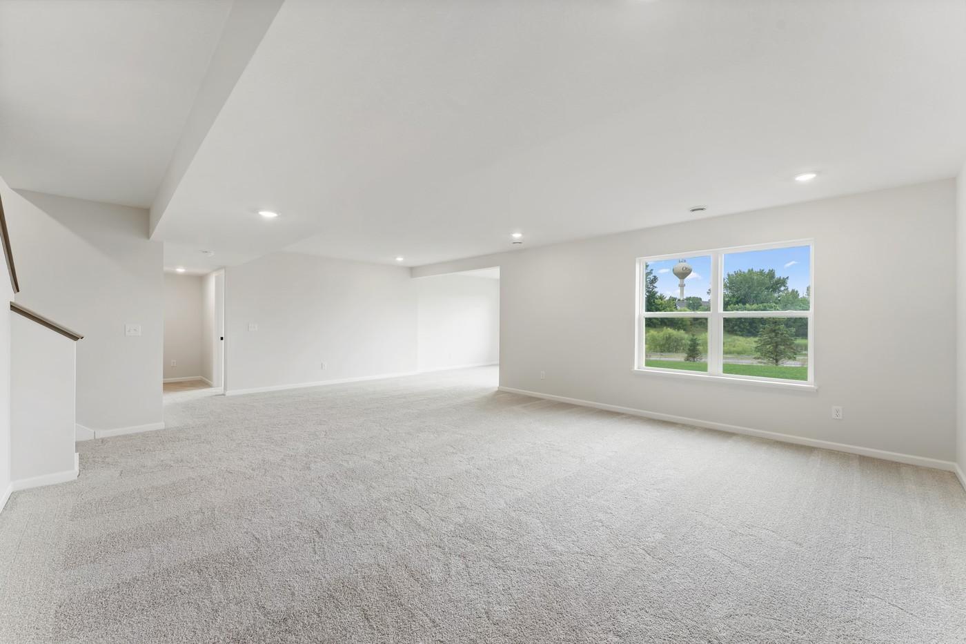 Finished lower level recreation area - Photo of a similar home.