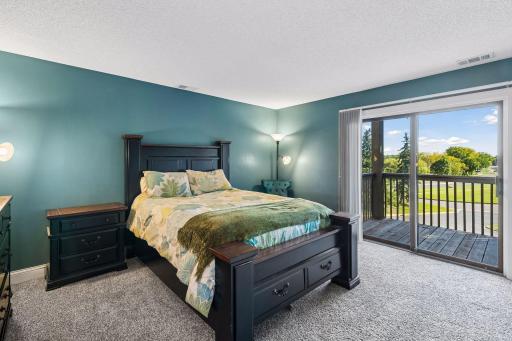 Primary bedroom with patio door to private covered deck.