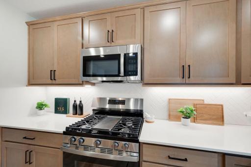 All appliances are included - stainless gas range, vented microwave, dishwasher, and refrigerator.