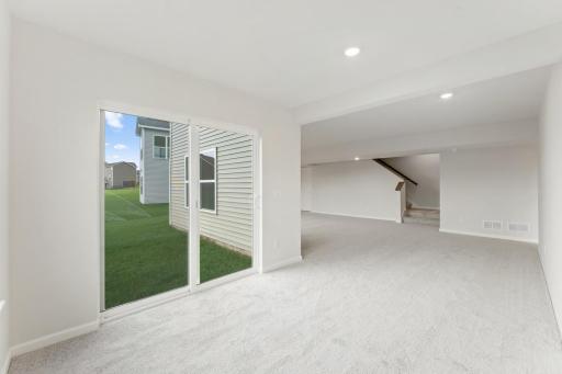 Finished lower level recreation area - photo of a similar home.