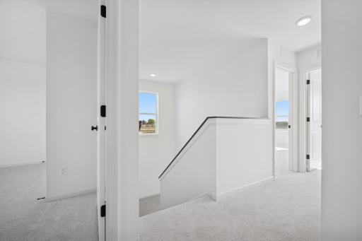 This spacious hallway connects all four bedrooms, making it easy for everyone to stay close while still enjoying their own space. Home under construction, photo of similar home, selections vary.