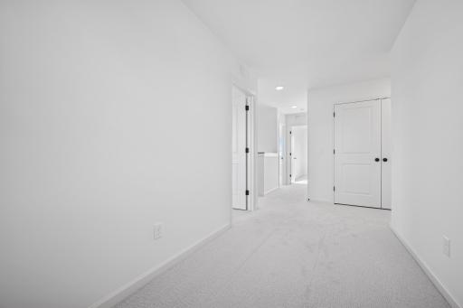 This spacious hallway connects all four bedrooms, making it easy for everyone to stay close while still enjoying their own space.Home under construction, photo of similar home, selections vary.
