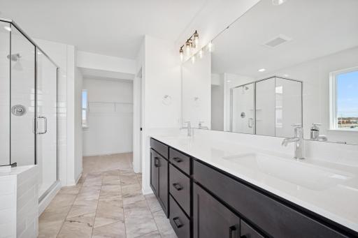 Start and end your day in this spa-like ownerâs bath featuring a soaking tub, walk-in shower, and double vanity. Home under construction, photo of similar home, selections vary.