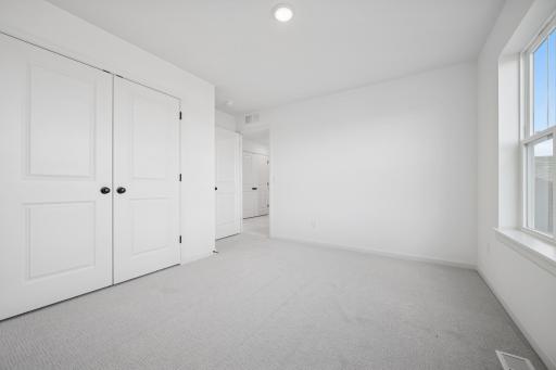 A bright and versatile space thatâs perfect as a kidsâ room, guest bedroom, or cozy home office. The large window and ample closet make it both practical and inviting.Home under construction, photo of similar home, selections vary.