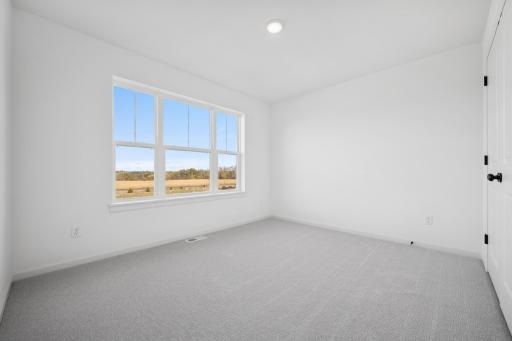 A bright and versatile space thatâs perfect as a kidsâ room, guest bedroom, or cozy home office. The large window and ample closet make it both practical and inviting. Home under construction, photo of similar home, selections vary.