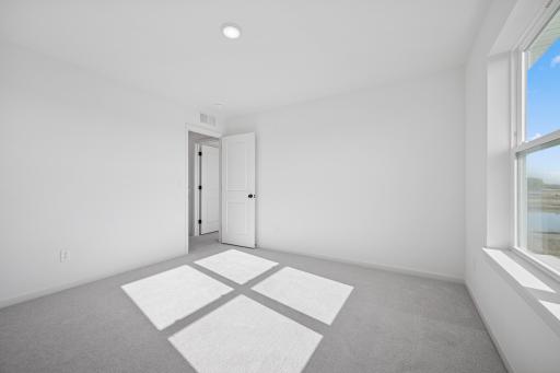 A bright and versatile space thatâs perfect as a kidsâ room, guest bedroom, or cozy home office. The large window and ample closet make it both practical and inviting. Home under construction, photo of similar home, selections vary.