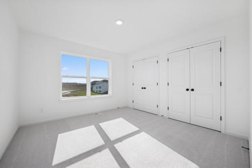 A bright and versatile space thatâs perfect as a kidsâ room, guest bedroom, or cozy home office. The large window and ample closet make it both practical and inviting. Home under construction, photo of similar home, selections vary.