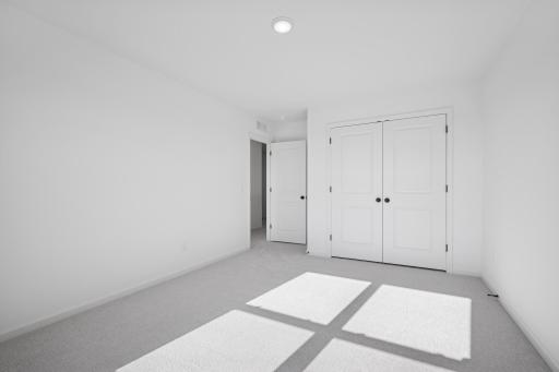 A bright and versatile space thatâs perfect as a kidsâ room, guest bedroom, or cozy home office. The large window and ample closet make it both practical and inviting. Home under construction, photo of similar home, selections vary.