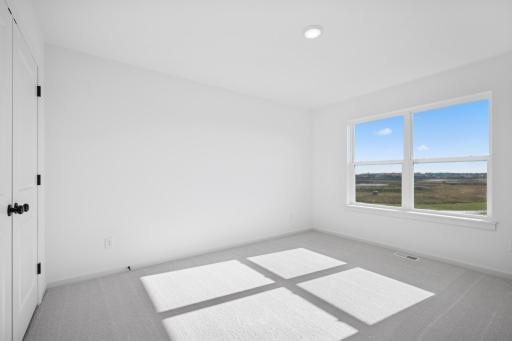 A bright and versatile space thatâs perfect as a kidsâ room, guest bedroom, or cozy home office. The large window and ample closet make it both practical and inviting.Home under construction, photo of similar home, selections vary.