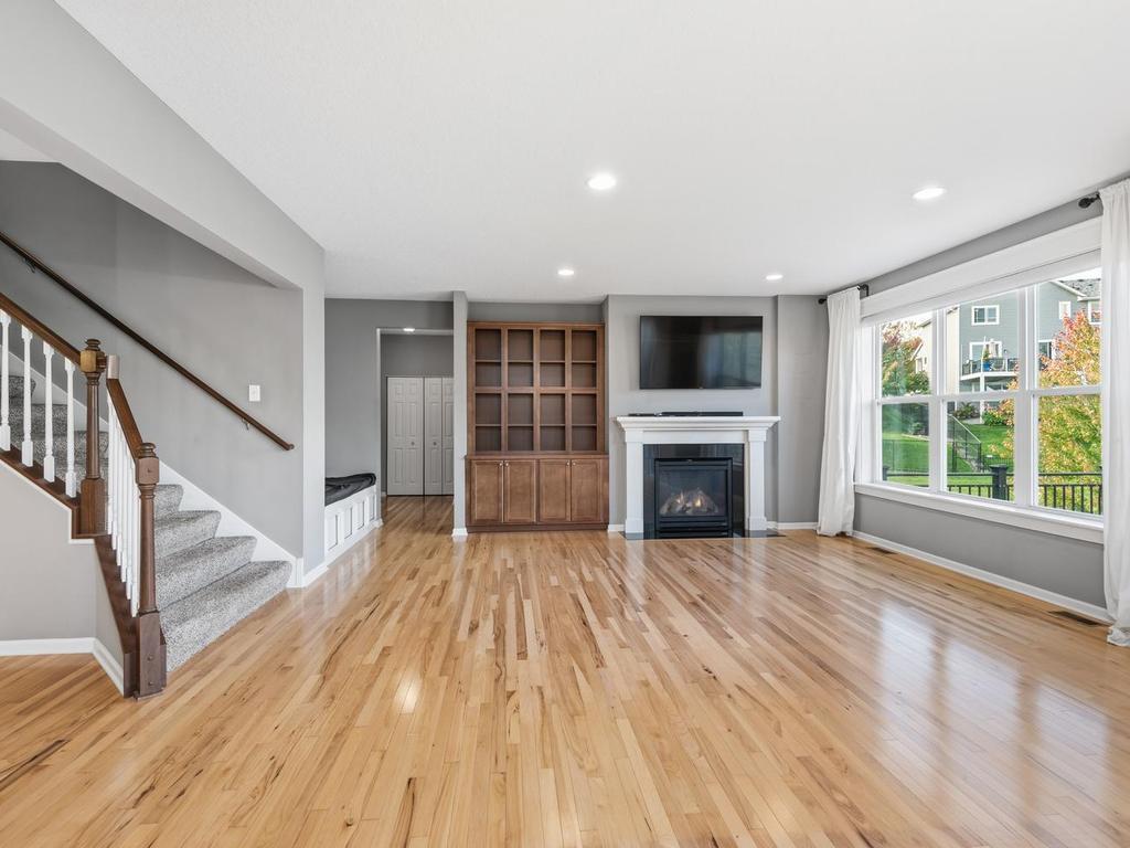 Spacious MF living with HW floors, Built-in bookcase, Gas FPLC and custom window treatments!