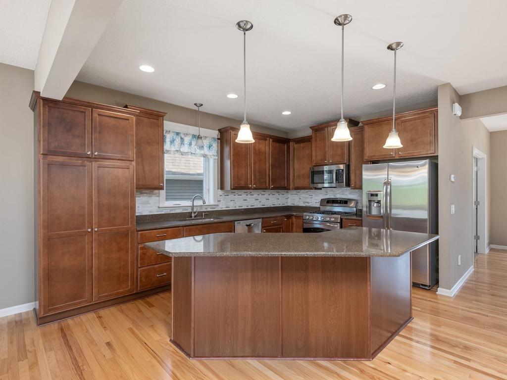 Large kitchen with stainless appliances, tile backsplash with loads of storage!