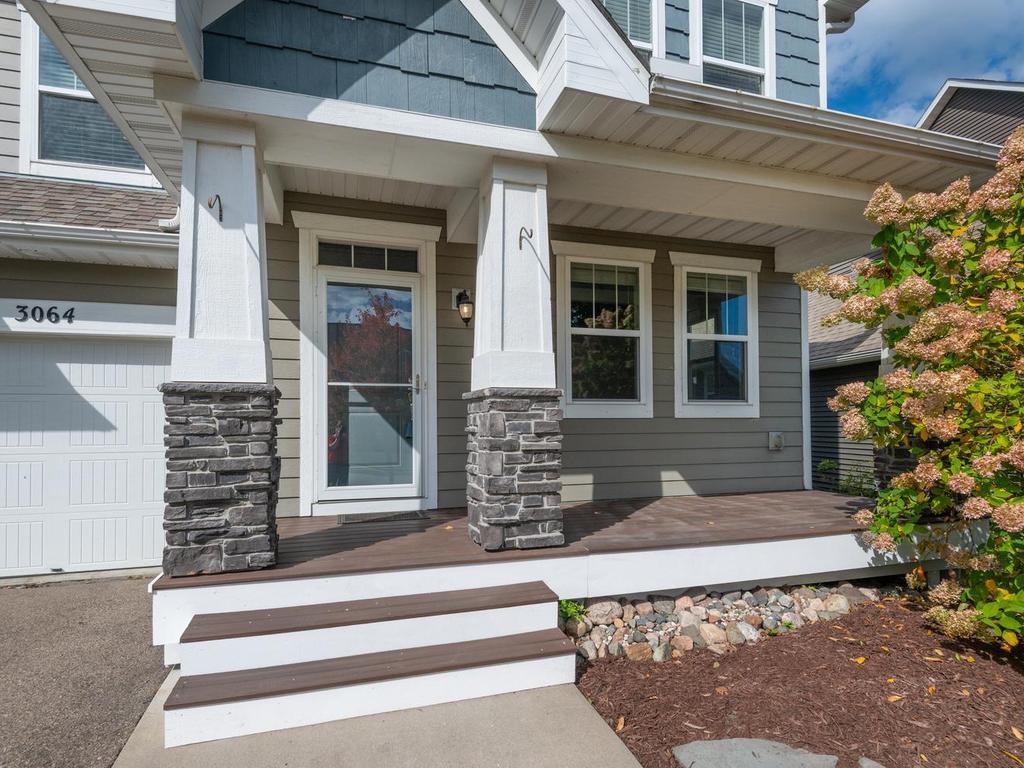 Welcoming south facing front porch! Stone accent pillars and great spot for morning coffee!
