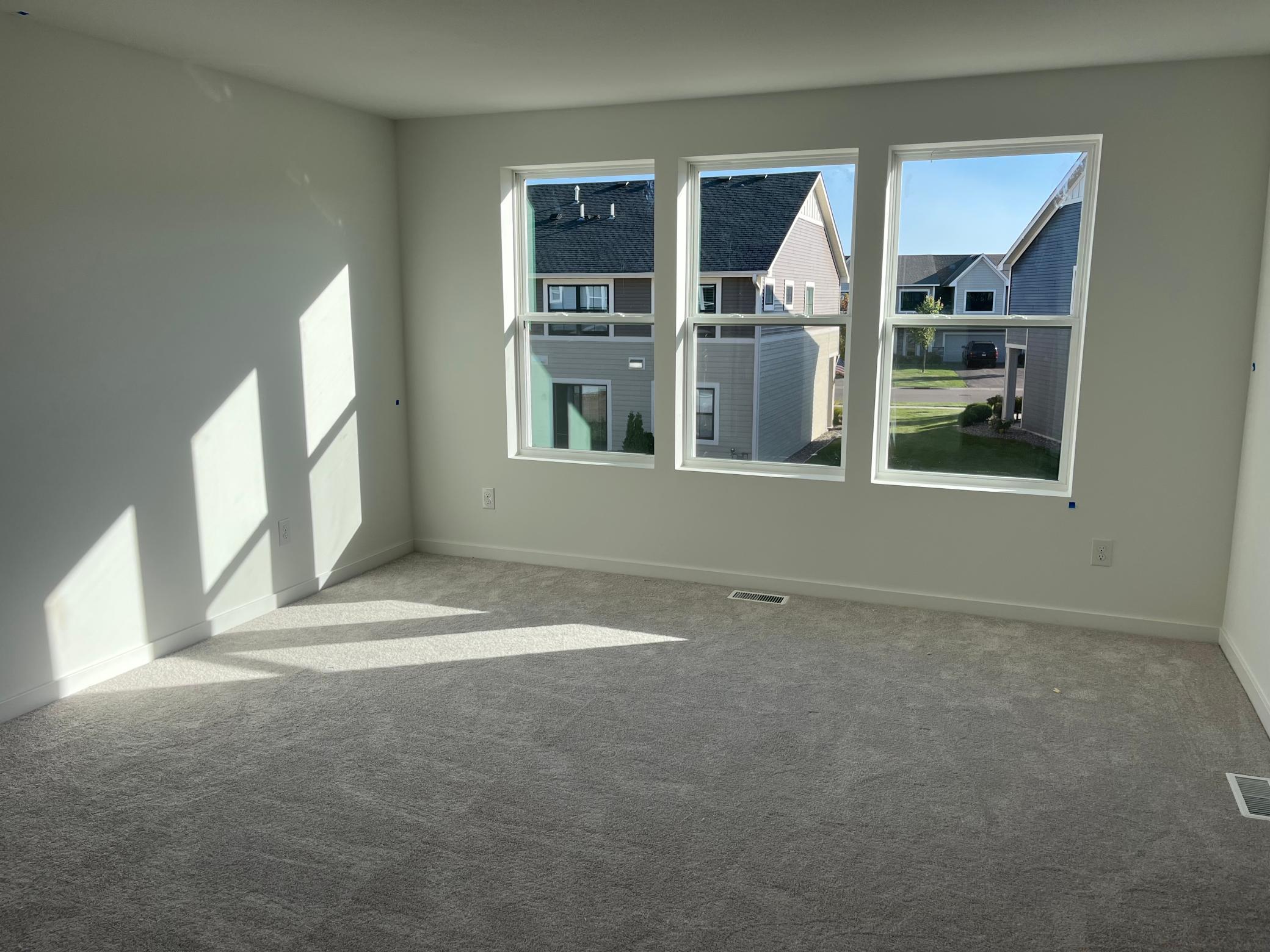 Primary bedroom with three windows