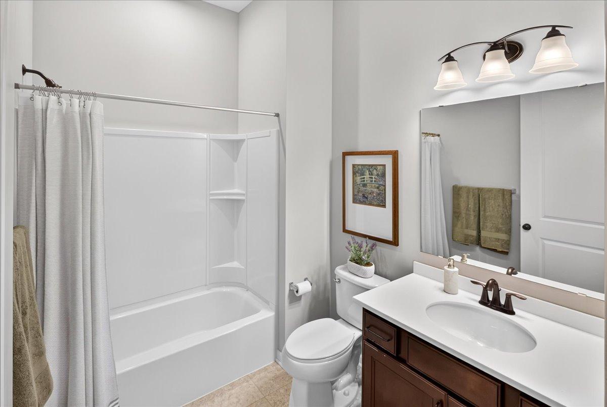 Nicely maintained bathroom with a tub/shower combination, vanity storage, and neutral finishes.
