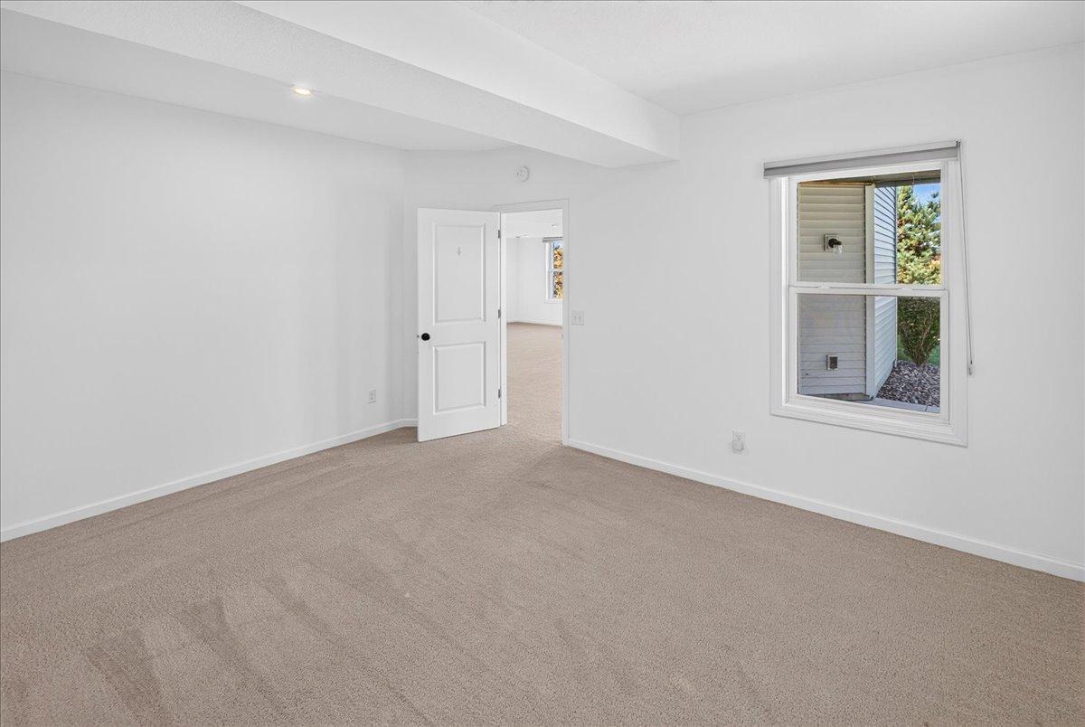 Spacious lower-level (3rd) bedroom with neutral finishes, closet storage, and flexibility for guests or a home office.