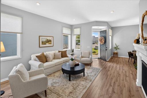 Generous living room with multiple windows, attractive flooring, and plenty of space for relaxing or entertaining