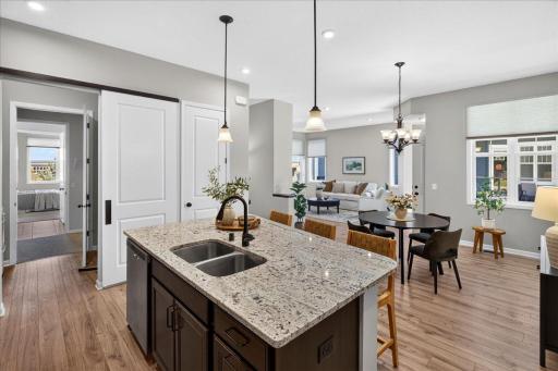 The kitchen opens to the dining and living areas, creating a connected, welcoming space filled with natural light.